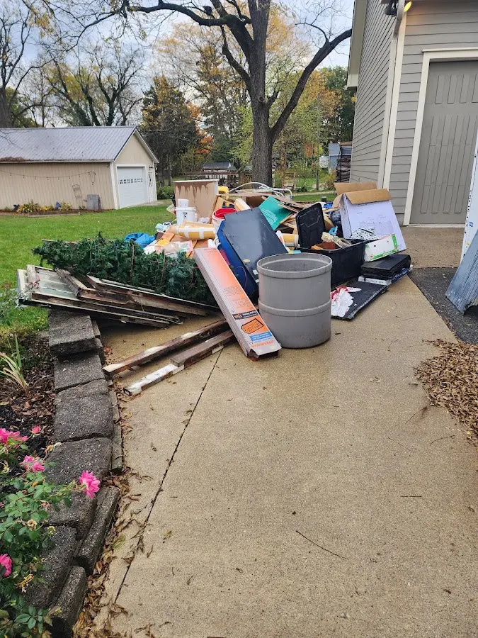 Dumpster being loaded with debris for 10 Yard Dumpster Rental in Canton